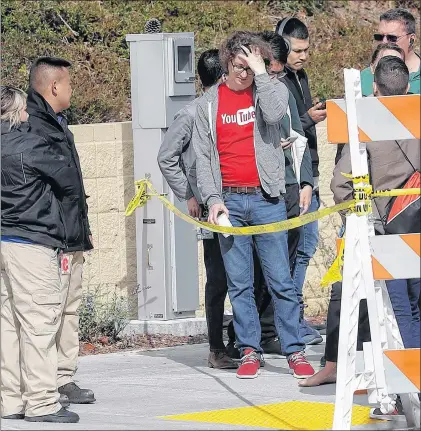  ?? AP PHOTO ?? People wait to be escorted into a Youtube office building in San Bruno, Calif., April 4 after a woman stormed the offices, shooting three people before killing herself.