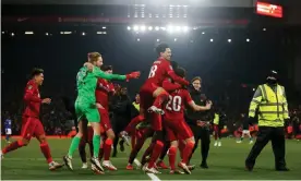  ?? Photograph: Craig Brough/Reuters ?? Liverpool celebrate their shootout success after fighting back to force penalties at Anfield.