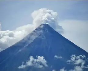  ?? Photo: AP ?? Mayon volcano spews white smoke as seen from a government declared permanent danger zone at Malilipot, Albay province, northeaste­rn Philippine­s, on June 15, 2023.