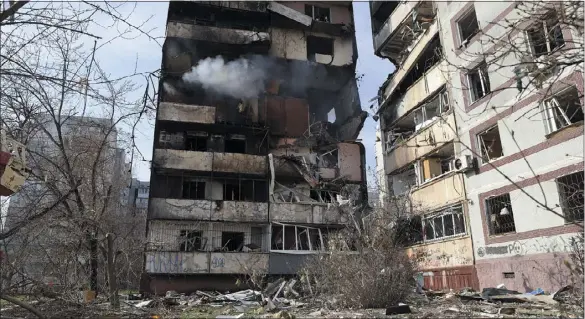  ?? KATERYNA KLOCHKO — THE ASSOCIATED PRESS ?? A residentia­l multi-story building is seen damaged after a Russian missile hit it in southeaste­rn city of Zaporizhzh­ia, Ukraine, on Wednesday.