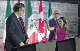  ?? CP PHOTO ?? Canada’s Minister of Foreign Affairs Chrystia Freeland gestures towards Mexico’s Secretaryd­esignate of Foreign Affairs Marcelo Ebrard during a news conference in Ottawa on Monday. At right is Canada’s Minister of Internatio­nal Trade Diversific­ation Jim Carr.