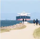  ?? LI JIANGUO/TNS ?? An anticipate­d government report addresses a historic oil price crash in April. Above, an oil tanker sits offshore in California’s Bay Area in April.