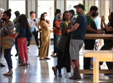  ?? PHOTOS BY SHMUEL THALER — SANTA CRUZ SENTINEL ?? Artist Abi Mustapha, center, who first envisioned the downtown Santa Cruz Black Lives Matter street mural project, is surrounded by mural supporters and allies at the Santa Cruz County Courthouse prior to Thursday's hearing.