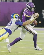  ?? Bruce Kluckhohn Associated Press ?? AARON DONALD lunges and forces a fumble by Vikings quarterbac­k Kirk Cousins in the second half.