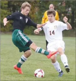  ?? Randy Meyers/Sports@MorningJou­rnal.com ?? Elyria Catholic’s Tanner Brooks, left, tries to kick the ball away from Austin Smith of North Ridgeville on Oct. 10 at North Ridgeville. The teams tied, 3-3.