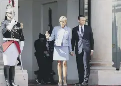  ??  ?? 0 Mr Macron and his wife Brigitte Trogneux at the Elysee Palace