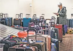  ?? GABRIELA CAMPOS NEW MEXICAN FILE PHOTO ?? Ruth Ann Price looks for the last of her family’s five bags in December at the Southwest baggage claim at the Albuquerqu­e Internatio­nal Sunport. The airline canceled thousands of flights during holiday chaos it blamed on weather and staffing issues. U.S. officials say about 6 of every 1,000 bags that flew on U.S. carriers in 2022 were lost, damaged, delayed or stolen.