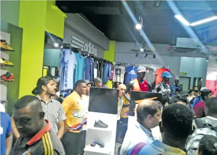  ?? Photo: Charles Chambers. ?? Customers rush for the opening specials at Jack’s Sports Shop at Vitogo Parade in Lautoka.