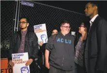  ?? Al Drago / New York Times 2017 ?? Gavin Grimm (center), an advocate for transgende­r rights, joins a protest outside the White House in Washington in 2017.