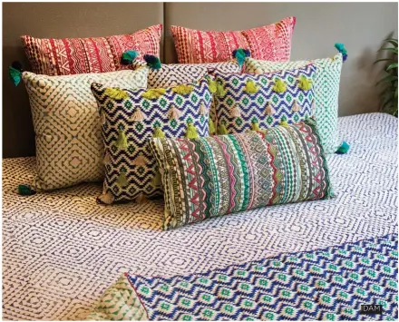  ??  ?? IDAM Tons of pillows in vintage textiles checks off all the boxes to master the art of bohemian decor. Pattern on pattern or texture on texture gives a cozy feel to the space as well.