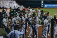  ?? BOB LEVEY — GETTY IMAGES ?? The A’s walk off the field, as do the Houston Astros, after both teams elected not to play in protest of racial injustice.