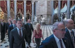  ?? J. SCOTT APPLEWHITE — THE ASSOCIATED PRESS ?? House Republican impeachmen­t managers walk to the Senate as they deliver the articles of impeachmen­t against Homeland Security Secretary Alejandro Mayorkas on Tuesday. In front row at left are House Homeland Security Committee Chairman Mark Green, R-tenn., and Rep. Marjorie Taylor Greene, R-GA. In second row are House Foreign Affairs Committee Chairman Michael Mccaul, R-texas, and Rep. Clay Higgins, R-LA., followed by Rep. Andy Biggs, R-ariz., Rep. Michael Guest, R-miss., and others.