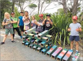  ?? PICTURE / SUPPLIED ?? Mangonui School children with the pest monitoring tunnels they made for Rangikapit­i.