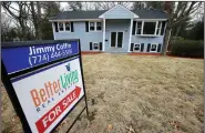  ?? AP file photo ?? A sign stands in front of a house in Walpole, Mass., last month. Sales of existing U.S. homes rose in February, the National Associatio­n of Realtors said Wednesday.