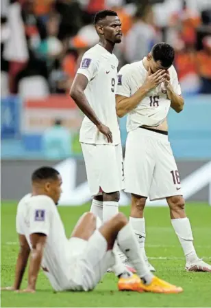  ?? /JOHN SIBLEY/REUTERS ?? Mohammed Muntari and Boualem Khoukhi can’t hide their dejection after a loss, condemning Qatar to an early exit.