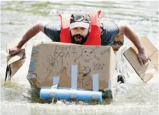  ??  ?? Adam Strunk lunges forward in The Death Boat during the Cardboard Regatta, a community event sponsored by Harvey County Now. He still holds the unofficial course record. (Photo by Wendy Nugent).