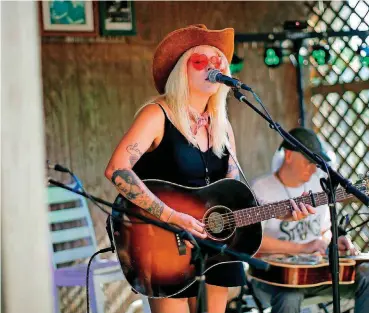  ?? [PHOTOS BY BRYAN TERRY, THE OKLAHOMAN ARCHIVES] ?? Jaimee Harris performs a song by the late Jimmy LaFave on July 12 during the Woody Guthrie Folk Festival in Okemah.