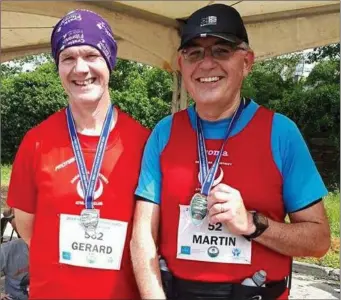  ??  ?? Gerard Fay and Martin Woods sheltering from the sun before the Newry Half Marathon.