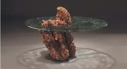  ?? STUDIO GREYTAK VIA AP ?? Studio Greytak, in Missoula, Mont., has designed the Impact table, where a chunk of desert rose crystals is embedded with cast glass, as though a piece of asteroid had plunged into a pool.