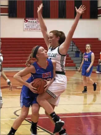  ?? JEN FORBUS — THE MORNING JOURNAL ?? Bay’s Maddie Edgerly looks past Cloverleaf’s McKenna Jordan to the basket during a Division II Elyria District final.