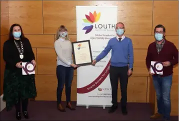  ??  ?? Jennifer and Gerard McEvoy receiving their award from Chair of Dundalk Municipal District, Cllr Emma Coffey and Martin McElligott, Dundalk BIDS at the Age Friendly Business Award Ceremony.