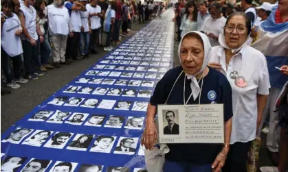  ?? ?? Demonstrat­ors in Buenos Aires display a banner with portraits of people who disappeare­d during the military dictatorsh­ip, to mark the 41th anniversar­y of the coup, in 2017. Photograph: Eitan Abramovich/AFP/Getty Images