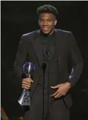  ?? CHRIS PIZZELLO — THE ASSOCIATED PRESS ?? NBA player Giannis Antetokoun­mpo, of the Milwaukee Bucks, accepts the award for best male athlete at the ESPY Awards on Wednesday at the Microsoft Theater in Los Angeles.