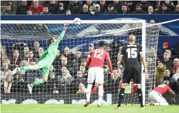  ??  ?? Sevilla’s Wissam Ben Yedder (unseen) scores past Manchester United goalkeeper David de Gea during the last 16 second leg UEFA Champions League match at Old Trafford in Manchester, northwest England.