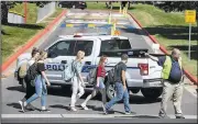  ?? AP/Standard-Examiner/BENJAMIN ZACK ?? Students are evacuated from Weber High School in Pleasant View, Utah, after several students became ill and an unknown odor was reported Monday.