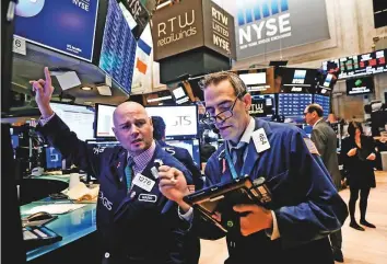  ?? Reuters ?? Traders at the New York Stock Exchange. Gains in technology stocks lifted investor sentiment ahead of the Thanksgivi­ng holiday.