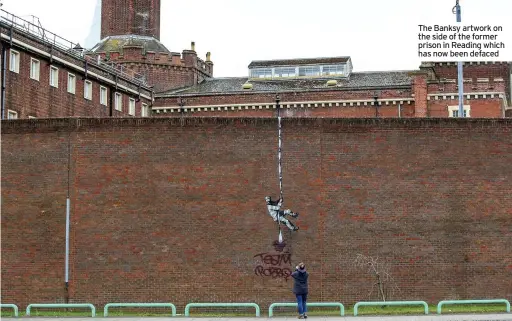  ??  ?? The Banksy artwork on the side of the former prison in Reading which has now been defaced