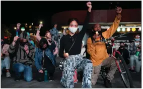  ?? (AP/John Minchillo) ?? Protesters kneel and raise their fists as they listen to speeches Oct. 14 during a rally held outside the Barclays Center in New York in remembranc­e of George Floyd.