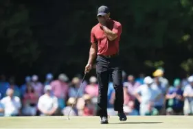  ?? AP PHOTO/CHARLIE RIEDEL ?? Tiger Woods wipes his face on the 15th hole at Augusta National Golf Club during the final round of the Masters on Sunday.