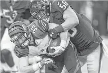  ?? Brett Coomer / Houston Chronicle ?? Texans linebacker Brian Cushing, right, slams Bengals running back Rex Burkhead to the turf in the fourth quarter.