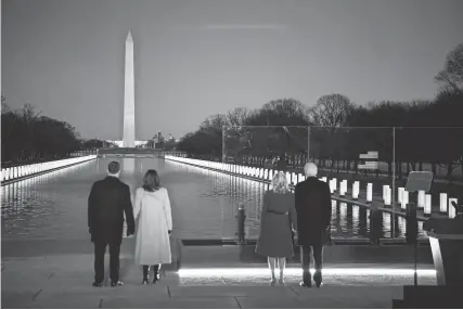  ?? HANNAH GABER/USA TODAY ?? President-elect Joe Biden and his wife Jill Biden are joined by Vice President-elect Kamala Harris and her husband Doug Emhoff during a COVID-19 memorial event at the Lincoln Memorial Reflecting Pool, on Tuesday.