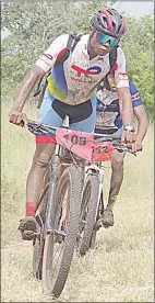  ?? ?? 4eva Cycling Club cyclist and runner-up Sihawu Dlamini negotiates a corner at the Mhlosinga Nature Reserve. He is followed by the eventual winner Kwanele Jele.