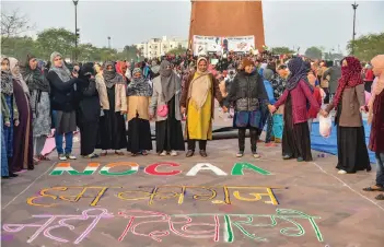  ?? — PTI ?? Muslim women stage a protest against CAA and NRC near Ghantaghar in old city area of Lucknow on Monday.