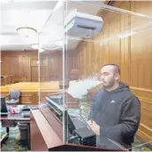  ?? MARY ALTAFFER/AP ?? Contractor Jimmy Griffenkra­nz demonstrat­es how a HEPA filter works with a smoke test March 12 at a federal courthouse in Manhattan.