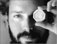  ?? THE ASSOCIATED PRESS — THE COLUMBUS DISPATCH, LON HORWEDEL ?? In this November 1989photo, Tommy Thompson holds a $50pioneer gold piece retrieved earlier in 1989from the wreck of the gold ship Central America.