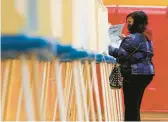  ?? MORRY GASH/AP ?? A voter casts a ballot on Nov. 3, 2020, at Marshall High School in Milwaukee. Then-President Donald Trump lost the state by nearly 21,000 votes to Democrat Joe Biden.