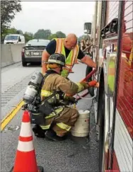  ??  ?? A tractor trailer carrying residentia­l trash caught on fire Tuesday morning, delaying traffic on the Route 30 Bypass westbound lanes. Firefighte­rs also used foam because it was a deep-seeded fire.