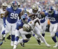  ?? JULIO CORTEZ — ASSOCIATED PRESS ?? New York Giants’ Landon Collins (21), center, tackles New Orleans Saints’ Alvin Kamara during the first half of an NFL football game, Sunday, Sept. 30, 2018, in East Rutherford, N.J.