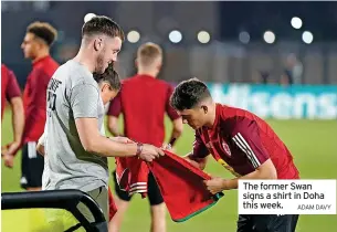  ?? ADAM DAVY ?? The former Swan signs a shirt in Doha this week.