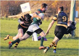  ??  ?? Going nowhere Roddy Beaton tackling for EK in their big win at Cambuslang