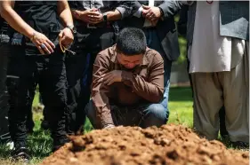  ?? (Chancey Bush/The Albuquerqu­e Journal via AP) ?? Altaf Hussain cries over the grave of his brother Aftab Hussein at Fairview Memorial Park in Albuquerqu­e, N.M., on Friday, Aug. 5, 2022. A funeral service was held for Aftab Hussein, 41, and Muhammad Afzaal Hussain, 27, at the Islamic Center of New Mexico on Friday. Both Muslim men were shot and killed near their homes only six days apart. Law enforcemen­t believes one suspect could be responsibl­e for killing three Muslim men in the past nine months.