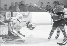  ?? DAVID BEBEE, RECORD STAFF ?? Elmira’s Anthony Azzano tries to tie up Listowel Cyclones’ Jamie Huber as the puck gets past Sugar Kings goalie Jon Reinhart in the first.