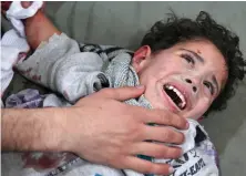  ??  ?? Injured: A Syrian child in eastern Ghouta yesterday