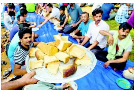  ??  ?? Ahmadi Muslim refugees wait to eat a meal at a community centre that they took refuge in Pasyala, north east of Colombo, Sri Lanka, Thursday, April 25, 2019.