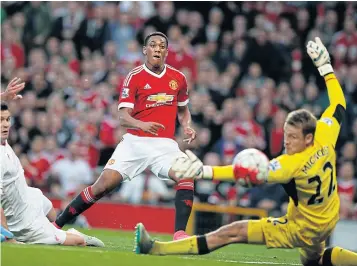  ?? AP ?? Manchester United’s Anthony Martial scores past Liverpool’s Simon Mignolet.