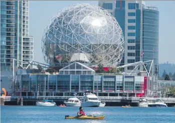  ?? RICHARD LAM ?? A kayaker takes to the waters of False Creek under blue skies and warm temperatur­es Friday. Environmen­t Canada says record temperatur­es could be reached over the next few days in the Lower Mainland.